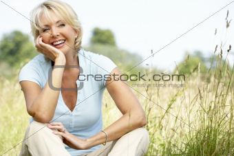 Portrait of mature woman sitting in countryside
