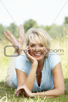 Portrait of mature woman relaxing in countryside