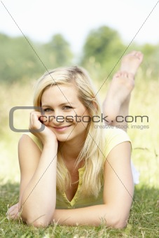 Portrait of young woman relaxing in countryside