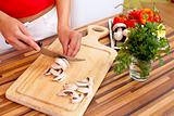 Woman cutting mushrooms