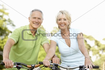 Mature couple riding bikes