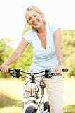 Portrait of mature woman riding cycle in countryside