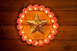 christmas candles circle over wood and symbol