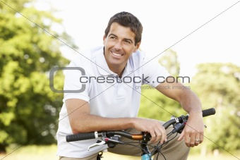 Young man riding bike in countryside