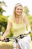 Young woman riding bike in countryside