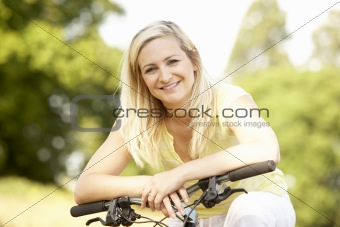Young woman riding bike in countryside