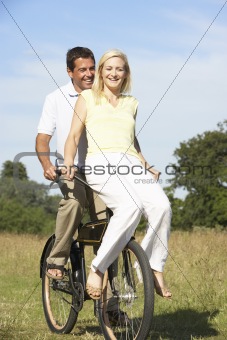 Young couple riding bike in countryside