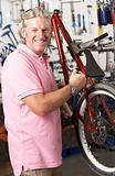Owner of cycle shop in workshop