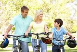 Parents And Son On Cycle Ride In Park