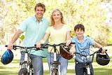 Parents And Son On Cycle Ride In Park