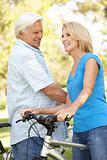 Senior Couple On Cycle Ride In Park