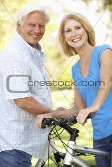 Senior Couple On Cycle Ride In Park