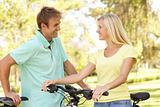 Young Couple On Cycle Ride in Park
