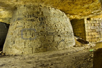 A massive column props set in the abandoned catacombs.