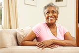 Senior Woman Relaxing In Chair At Home