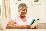 Senior Woman Reading Book At Home