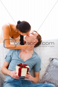 Young woman present gift to her husband
