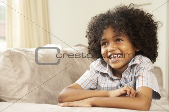 Young Boy Relaxing On Sofa At Home