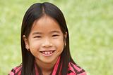 Portrait Of Smiling Young Girl Outdoors