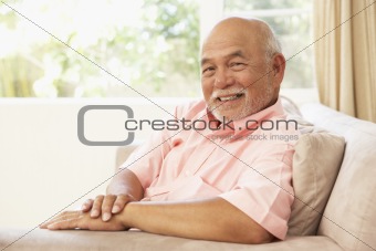 Senior Man Relaxing In Chair At Home