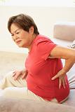 Senior Woman Suffering From Back Pain At Home