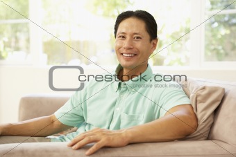 Young Man Relaxing On Sofa At Home