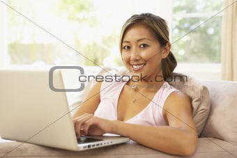 Young Woman Using Laptop At Home