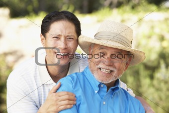 Senior Man With Adult Son In Garden