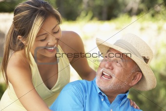Senior Man With Adult Daughter In Garden