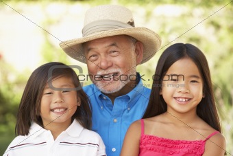 Grandfather With Grandchildren In Garden