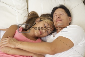 Young Couple Asleep In Bed