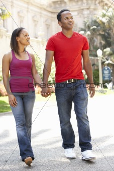 Young Couple Walking Through City Street