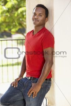 Young Man Leaning Against Pillar