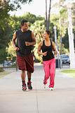 Young Couple Jogging On Street