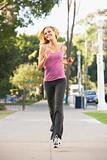 Young Woman Jogging On Street