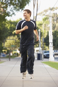 Young Man Jogging On Street