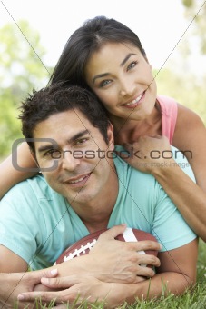 Couple In Park With American Football