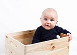 toddler in wooden box
