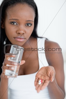 Close up of a woman taking pills
