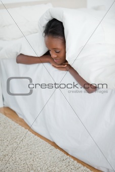 Portrait of a woman sleeping under her duvet