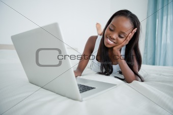 Young woman watching a movie on her notebook
