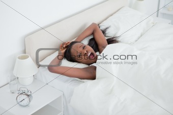 Woman yawning while waking up