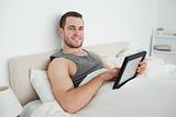 Smiling man using a tablet computer