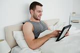 Happy man using a tablet computer