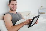 Attractive man using a tablet computer