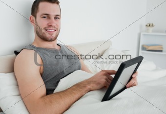 Attractive man using a tablet computer
