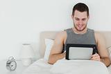 Peaceful man using a tablet computer