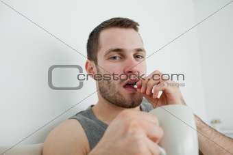 Young man taking a pill