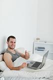 Portrait of a man purchasing online with thumb up