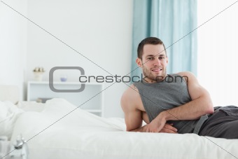 Man posing on his bed